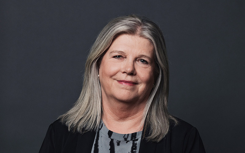 Portrait of Merete Bloch Hansen on dark grey background