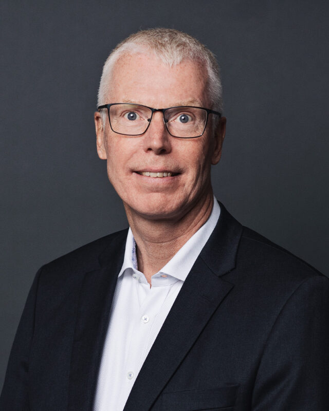 Finn Strøm Madsen, CEO, Plougmann Vingtoft on dark grey background