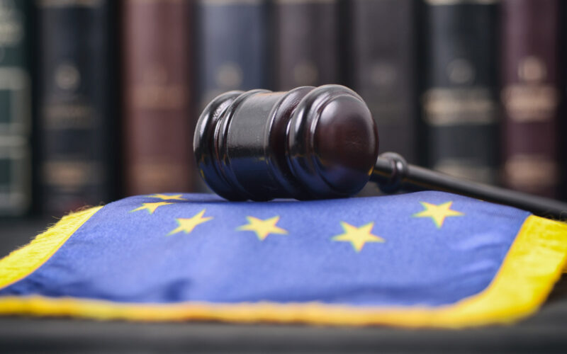 Hammer from court laying on the EU-flag